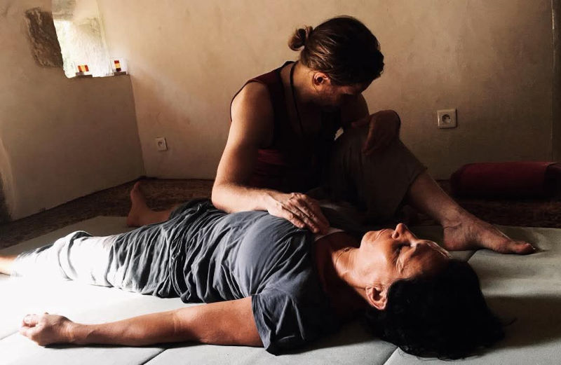 Robert Peirce providing touch therapy to a client